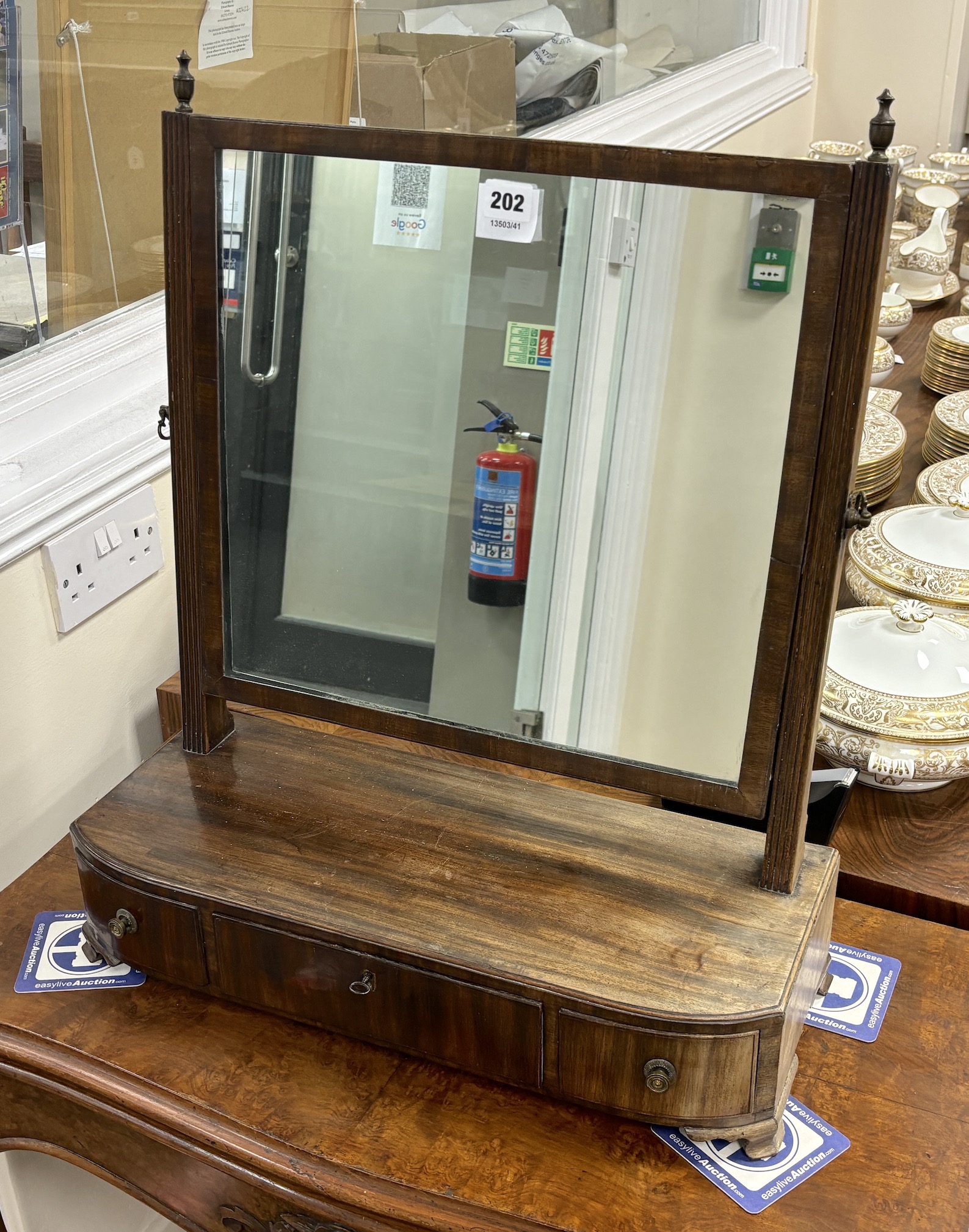 A George III mahogany bowfront toilet mirror, width 52cm, depth 21cm, height 62cm.